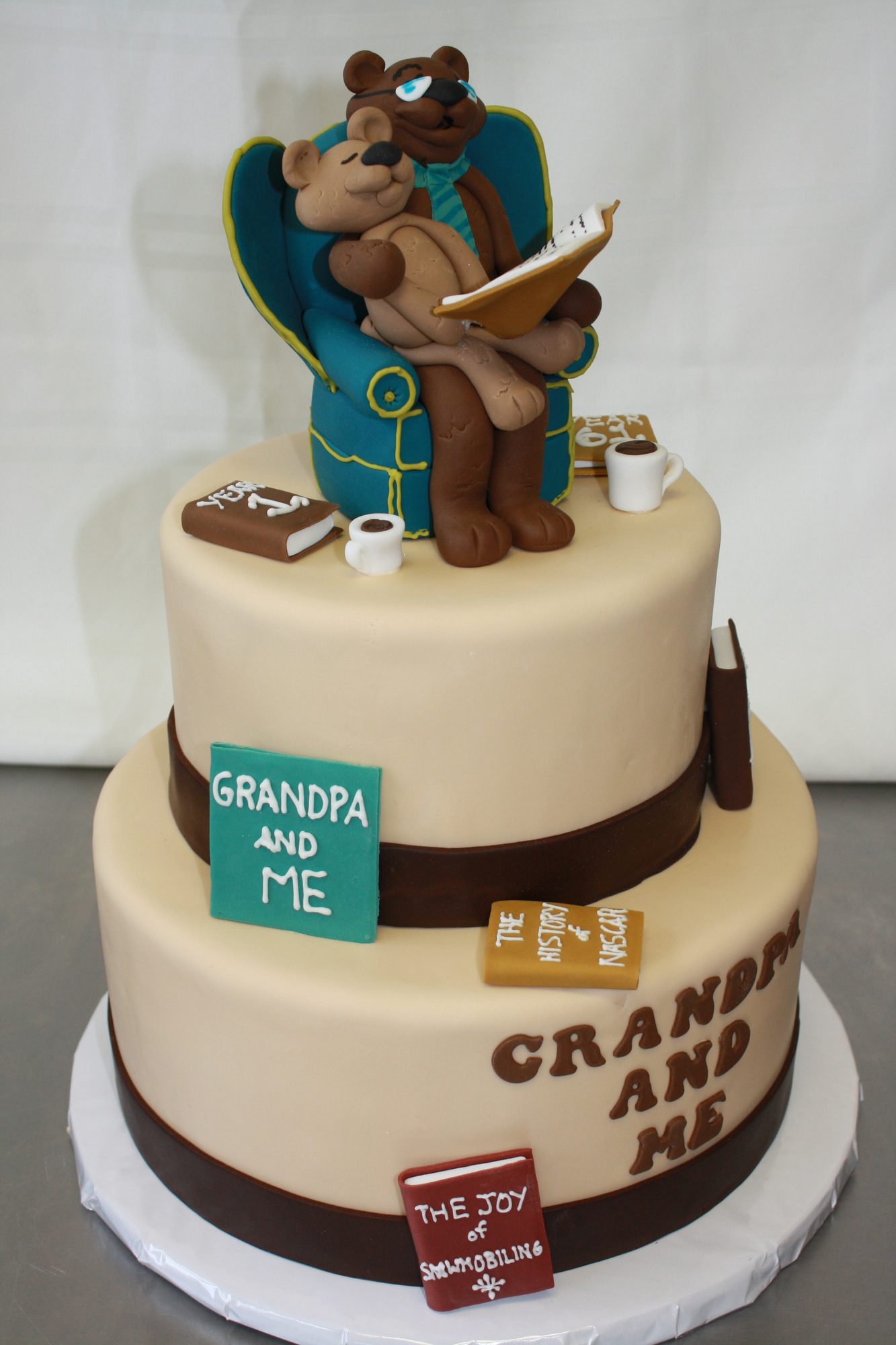 Grandfather and grandson birthday cake with a sculpted bear in an armchair